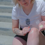 Hemplucid Vegan CBDa Body Cream 1000mg - Lifestyle Photo of Girl Applying CBDa Cream to her Knee