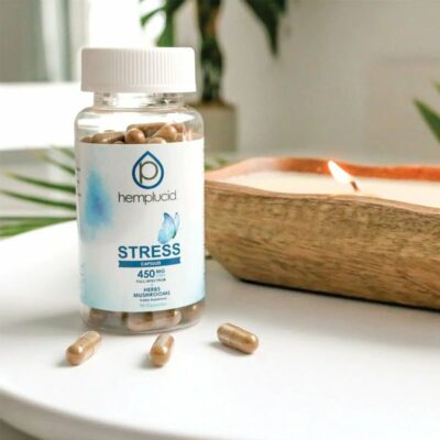 Stress Stacks CBD Capsules - Hemplucid - Photo of Stress Capsules Bottle on Table Next to a Candle