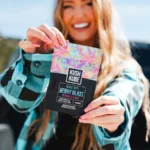 Kush Kube 500mg THC Blast Off Gummies - Girl Outside Holding Gummy Bag In Hand
