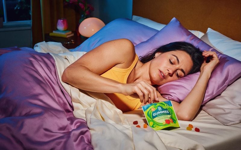 Adult lying awake in a cozy bedroom at night, looking for a THC free way to fall asleep
